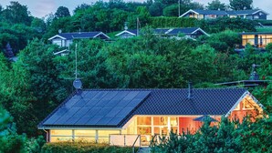 A modern house with a sloped roof, solar panels, and a glass front. - Awesome home in Ebeltoft with sauna (Ebeltoft)