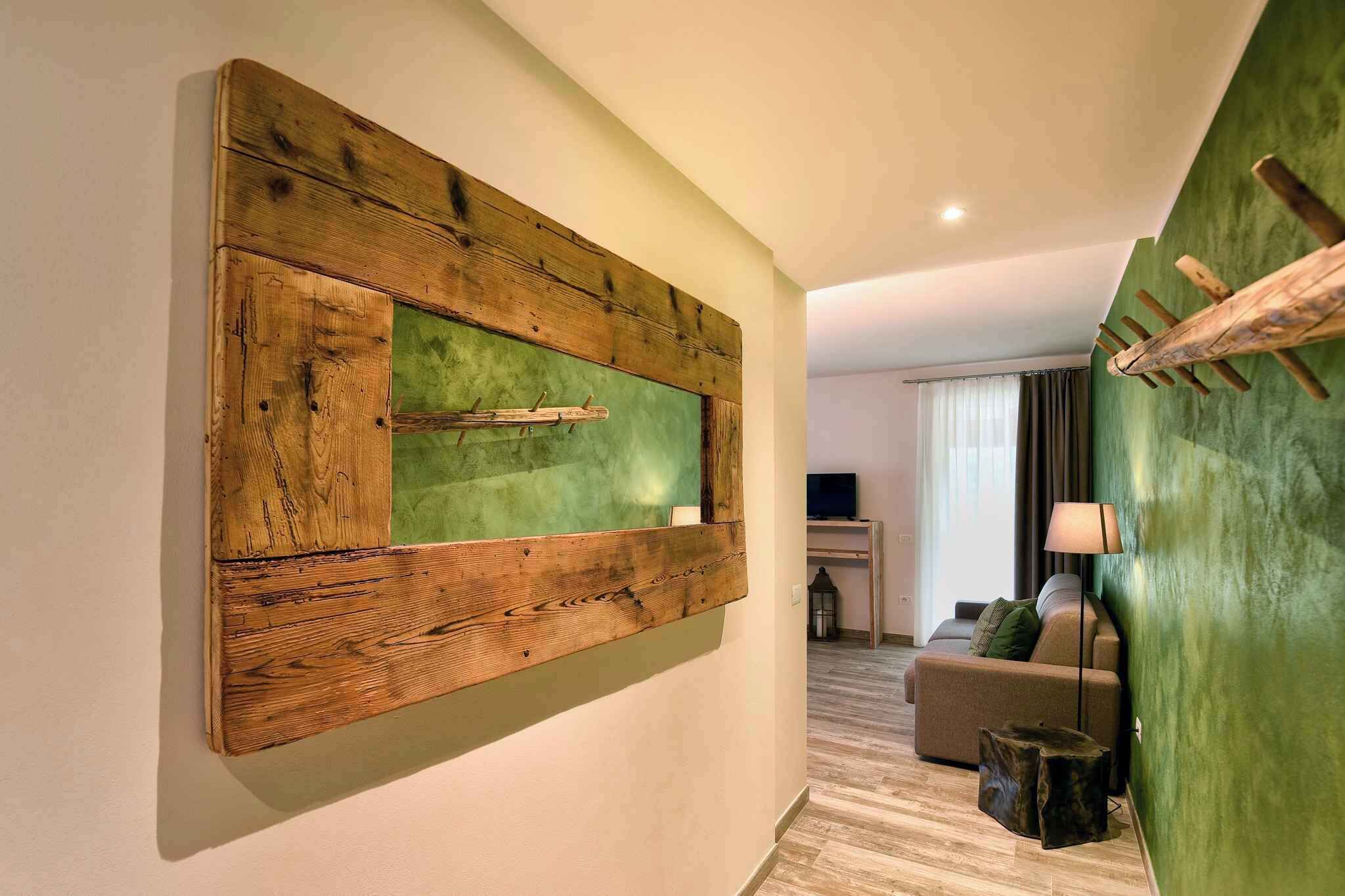 A modern living room with a large wooden wall art piece, a sofa, a coffee table, and a lamp.