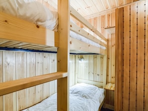 Cozy cabin-style room with bunk beds and simple, functional design.