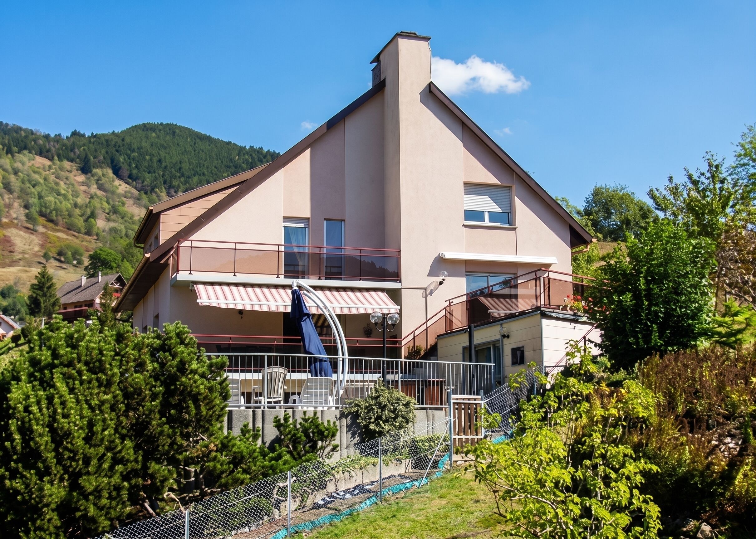 Un bâtiment à deux étages doté d’un balcon, d’une petite fenêtre et d’un espace extérieur visible, délimité par une clôture.
