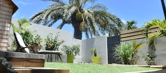 Charming outbuilding with large shaded terrace in private garden