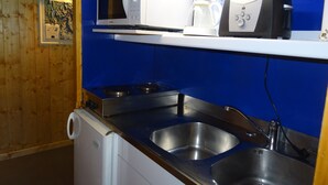 A kitchen with a microwave, coffee maker, and a dishwasher.