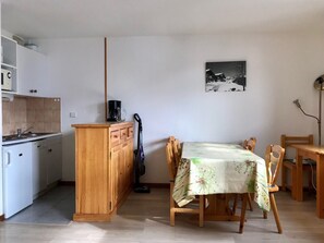 Enjoy a compact kitchenette with a sink, coffee maker, and vacuum cleaner. Dine at the central table and chairs.