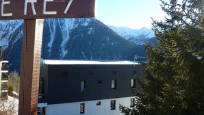 A building with a sign that reads "EREY" in front of a mountain backdrop.