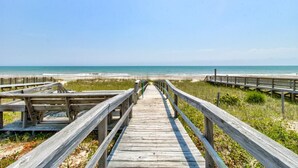 A wooden boardwalk leading to a beach with a clear view of the ocean. - ☀️Dolphin Run: Oceanfront w/ Private Pool-Large Beachfront Deck-Pet Friendly☀️ (Kure Beach)