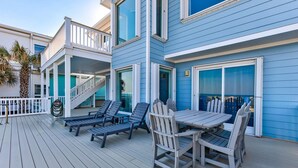 A deck with outdoor furniture, a staircase, and a poolside area. - ☀️Dolphin Run: Oceanfront w/ Private Pool-Large Beachfront Deck-Pet Friendly☀️ (Kure Beach)