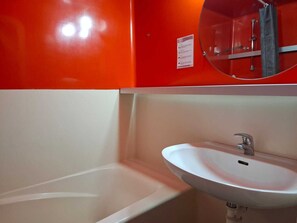 A bathroom with a white sink and a mirror above it. - Ski-in/ski-out studio for 4 at Arc 2000 (Les Arcs 2000)