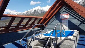 A pool area with a metal ladder and a signboard with safety instructions. - Amazing views ! Beautiful 2 bed/2 bath condo.,Free WiFi/Cable. Prime location! (Canmore)