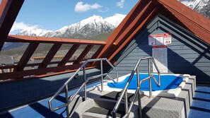 A pool area with a metal ladder and a signboard with safety instructions. - Amazing views ! Beautiful 2 bed/2 bath condo.,Free WiFi/Cable. Prime location! (Canmore)