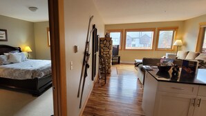 A bedroom with a bed, bedside lamps, a dresser, and a window. - Amazing views ! Beautiful 2 bed/2 bath condo.,Free WiFi/Cable. Prime location! (Canmore)