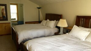 A bedroom with two beds, a nightstand with a lamp, a ceiling fan, and a window with blinds. - Cabin #1, Kentucky Lake,  Nashville , Birdsong Marina, Paris Landing, Memphis (Camden)