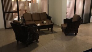 A living room with a sofa, two armchairs, and a coffee table.