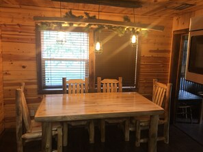 Cozy dining area with a wooden table and chairs, perfect for relaxation or entertainment.
