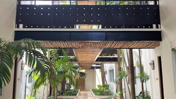 A multi-level indoor garden with a central pathway, bamboo ceiling, and potted plants. - Walk to Beach, Private rooftop, Pool, Parking, M3 (Playa del Carmen)