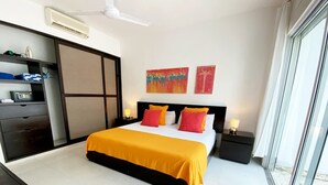 A hotel room with a bed, bedside tables, a desk, and a wardrobe. - Walk to Beach, Private rooftop, Pool, Parking, M3 (Playa del Carmen)