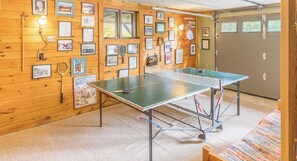 A ping pong table in a room with wooden walls adorned with framed pictures. - Tree House Feel in a Perfect Location<br> (Lake Placid)