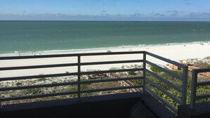 A balcony with a view of a beach and ocean. - 2 Bedroom, two bath 1500 SF unit with west views of sunsets (Marco Island)