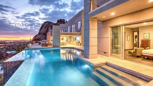 A modern hotel with a pool, a balcony, and a view of the cityscape. - Scottsdale Manor - 9BR Estate w/ Infinity Pool, Theater & Mountain Views (Phoenix)