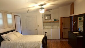 A bedroom with a bed, a ceiling fan, a washing machine, and a dresser. - Cabin # 2, Kentucky Lake, Bass Fishing, Camden, Tn, (Nashville 1, Memphis 1.5) (Camden)