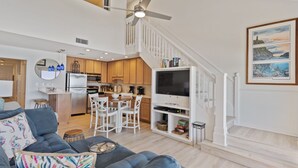 A modern living room with a sofa, a dining area, and a kitchen. - 44- Gorgeous BEACH FRONT Condo with Loft in Crystal Beach. Coral Reef Club (Destin)