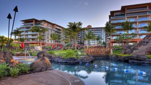 A hotel with a pool area, palm trees, and a multi-story building with balconies. - FABULOUS OCEAN VIEW, 6th FLOOR CONDO, “165-5 STAR REVIEWS” (Lahaina)