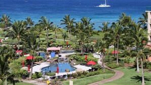A resort with a pool, palm trees, and a view of the ocean. - FABULOUS OCEAN VIEW, 6th FLOOR CONDO, “165-5 STAR REVIEWS” (Lahaina)