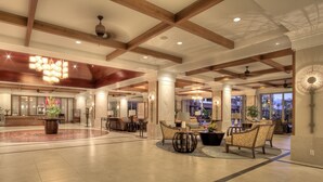 A spacious lobby with high ceilings, wooden beams, and a central seating area with patterned chairs. - FABULOUS OCEAN VIEW, 6th FLOOR CONDO, “165-5 STAR REVIEWS” (Lahaina)