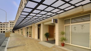 A hotel corridor with a glass facade, potted plants, and a sign indicating room number 2. - Hoya Resort Hotel Chiayi (Minxiong)