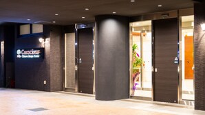 A hotel entrance with a sign reading "Cococious Monte Carlo Hotel". - Cococious Monpa (Chatan)