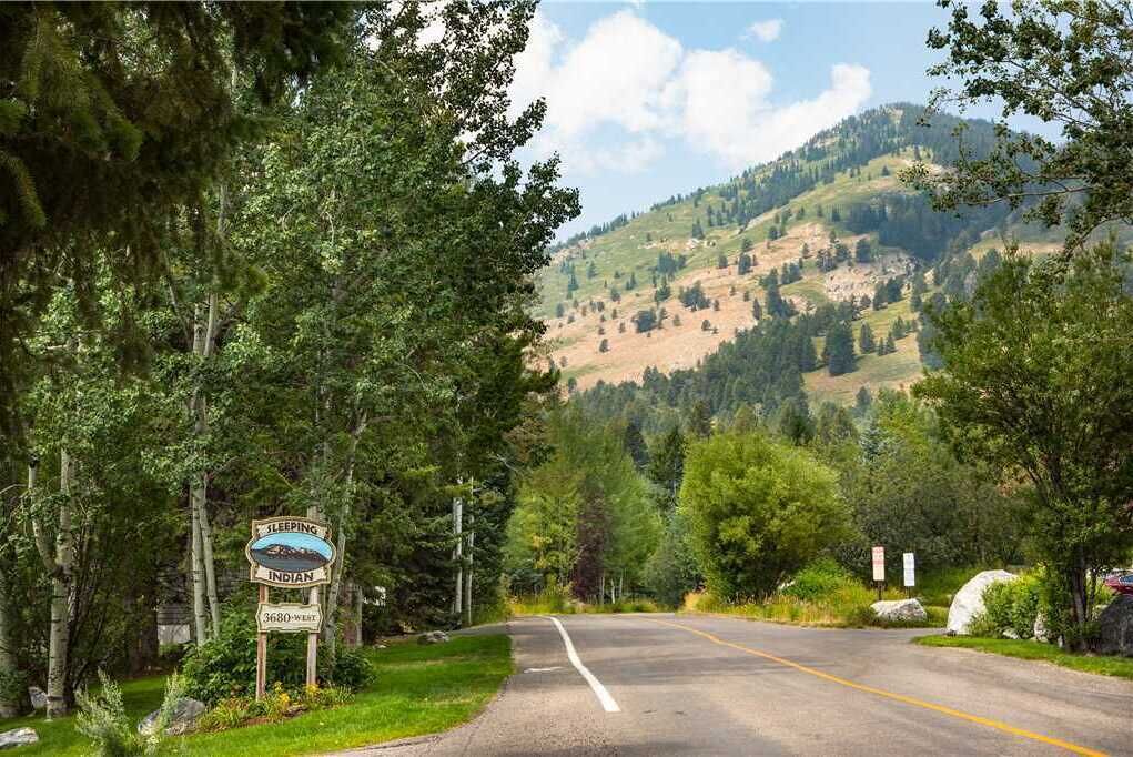 A road sign indicating the name 'Sleeping Indian' and the distance '3680-West'.