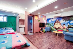 A children's room with a bed, a TV, a sofa, and a mural. - Jiutiandou Parent-Child House (Tainan)
