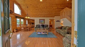A spacious living room with wooden floors, a coffee table, and two couches. - Pet-Friendly Modern Cabin w/ Hot Tub, Mountain Views + Biltmore Pass (Waynesville)