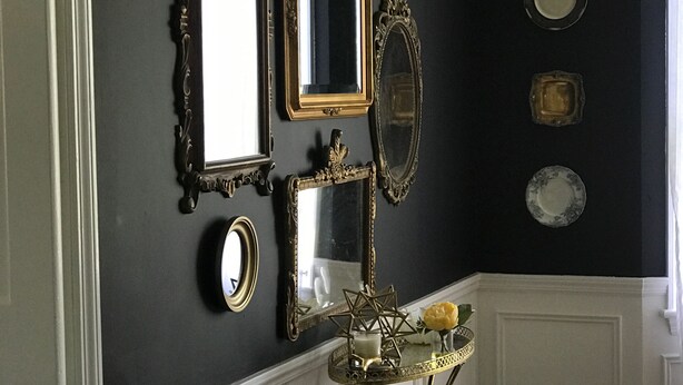 A room with a dark wall, a white wainscoting, and a small table with decorative items. - Gorgeous Private Countryside Getaway! (South Bend)