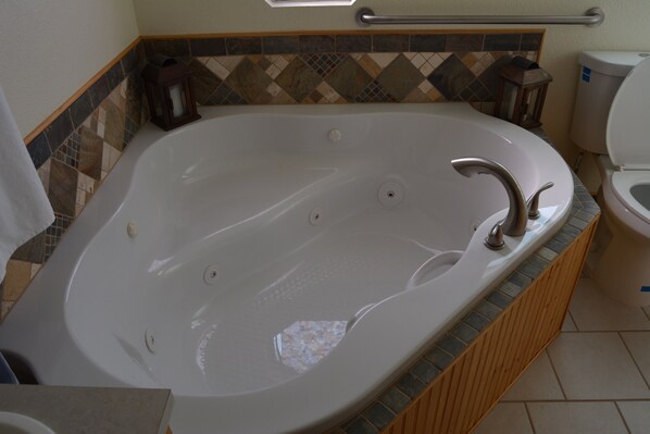 A bathroom with a large bathtub, a toilet, and a shower area. - !!! BEST Long Term in town. Spring Mountain, Death Valley - Retreat (Pahrump)