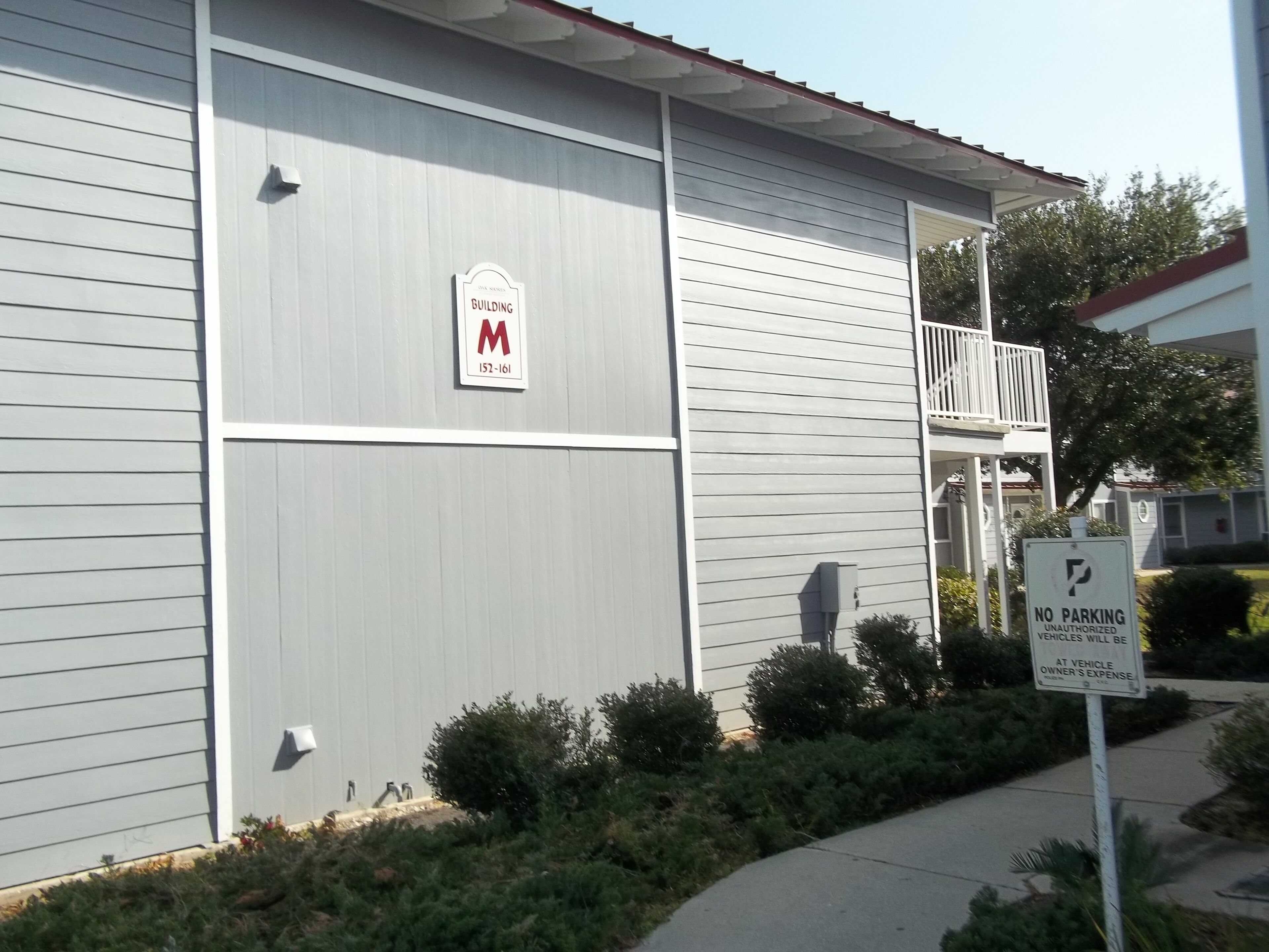 A building with a sign indicating 'The Knox Building' and '152-161'. There is a 'No Parking' sign visible.