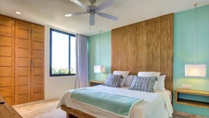 A bedroom with a bed, wooden wardrobe, ceiling fan, and a window with curtains. - Central Penthouse, Private Roof & Pool, Gym, 402 (Playa del Carmen)