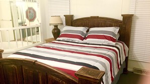 A bedroom with a wooden bed, white walls, and a window with blinds. - WW, Kentucky Lake, Bass Fish, Nashville, MEMPHIS, Birdsong Marina, Paris Landing (Camden)