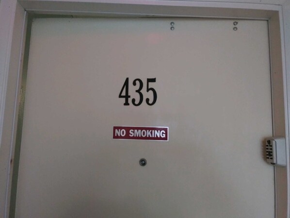 A door with the number 435 and a 'NO SMOKING' sign.