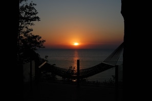 Relax in a hammock on a balcony overlooking the ocean.