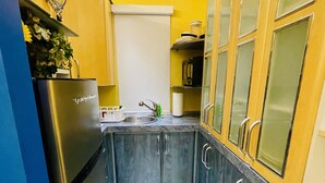 A compact kitchen with a refrigerator, sink, and cabinets. - Beautiful Condo -Ocean View, Best Location, Pool, A Few Steps to All You Want (Santurce)