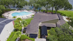 A residential area with a swimming pool, a tennis court, and a gazebo. - Lake Front - Ground Level - 2 bedroom 2 bath (Brandon)