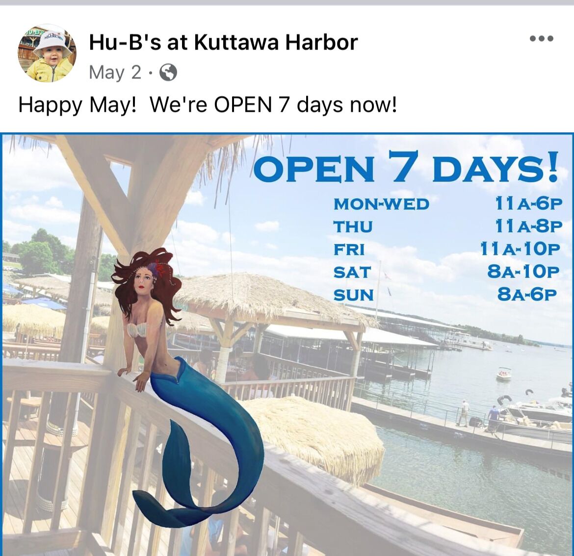 A mermaid illustration on a deck with a view of a harbor and boats.