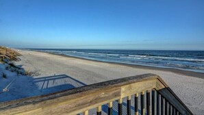 A wooden boardwalk leading to a sandy beach with ocean waves in the background. - Blue Shamu | Oceanfront + Screened Porch! (Topsail Beach)
