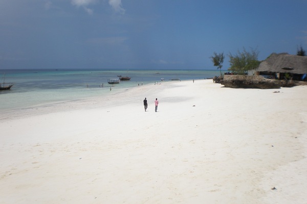 On the beach, white sand, sun loungers, beach umbrellas