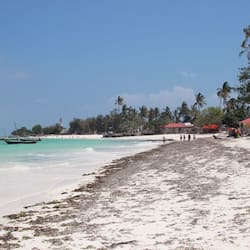 On the beach, white sand, sun-loungers, beach umbrellas