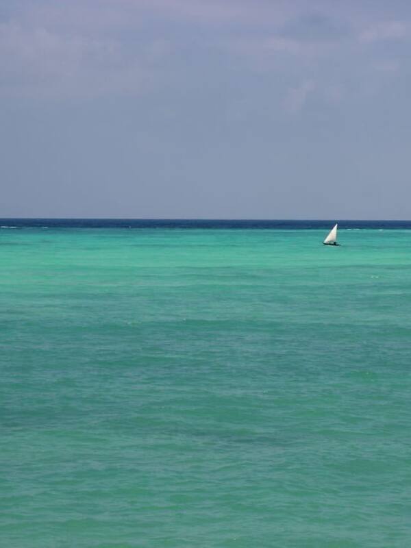 On the beach, white sand, sun-loungers, beach umbrellas