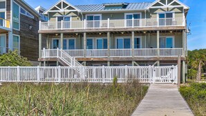 A multi-story beachfront building with a wooden deck and white railings. - ☀️As Good As It Gets-Oceanfront Home w/Private Pool☀️ (Kure Beach)