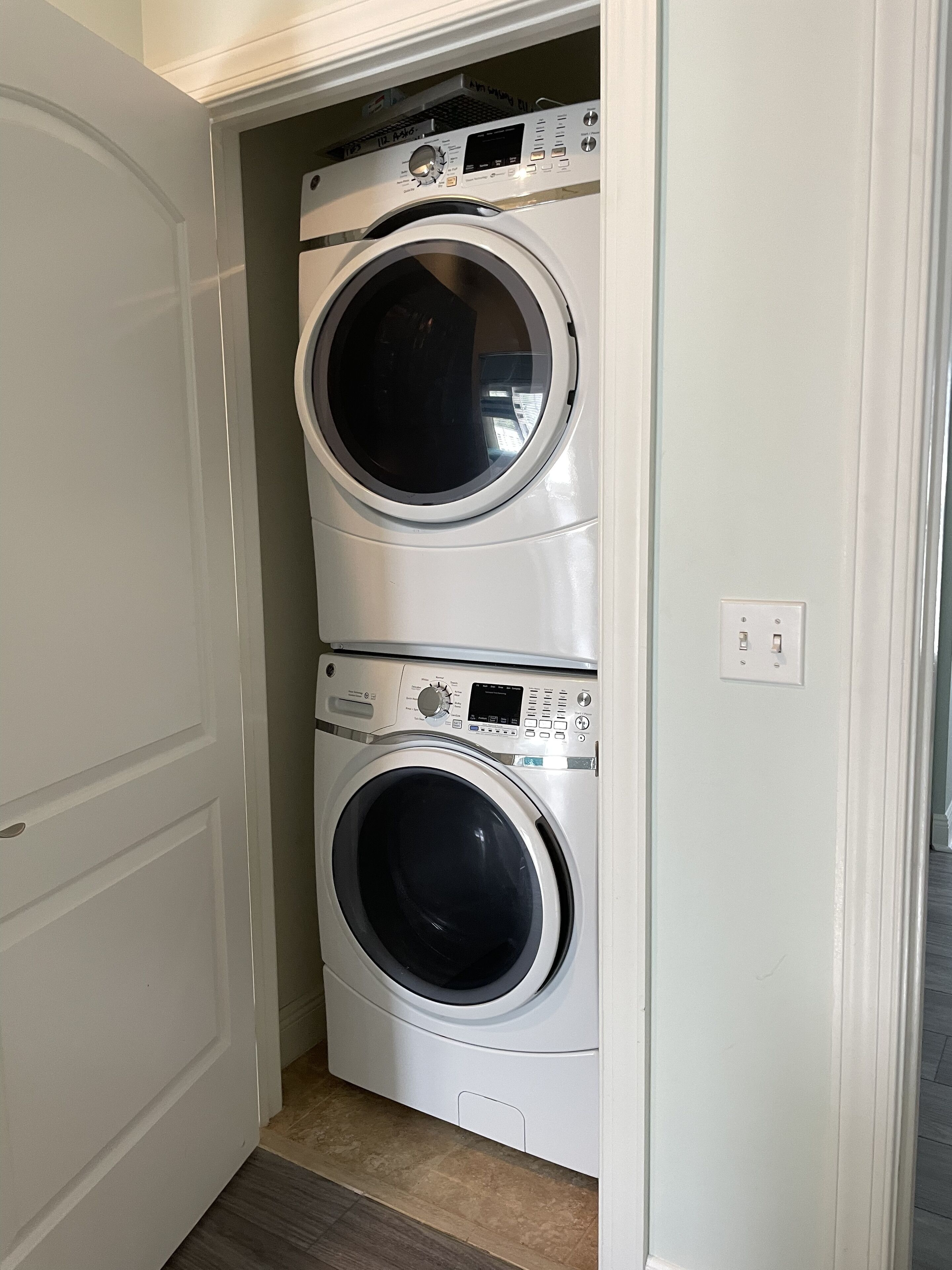 A laundry room with two stacked front-loading washing machines.