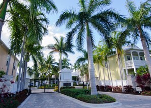Welcome to Angler's Cove, a serene residential area with beautifully landscaped gardens and a paved walkway.