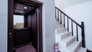 An interior view of a hotel with a staircase and an elevator. - Partyport-Hai (Tainan)